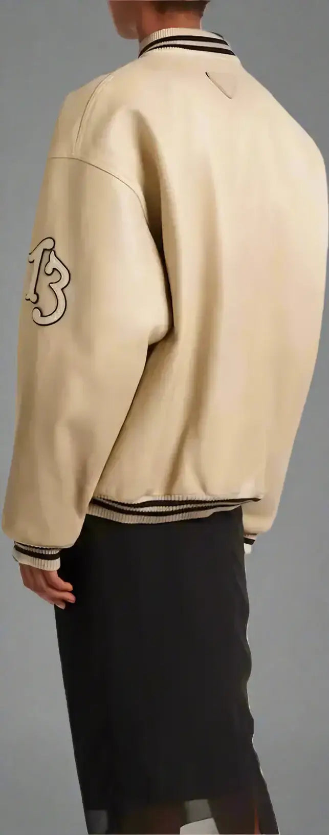 Cream-colored PRADA women’s padded leather varsity jacket with elasticated hem and striped cuffs