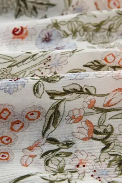 White fabric with a delicate floral pattern for Printed Mock Neck Long Sleeve Mini Dress