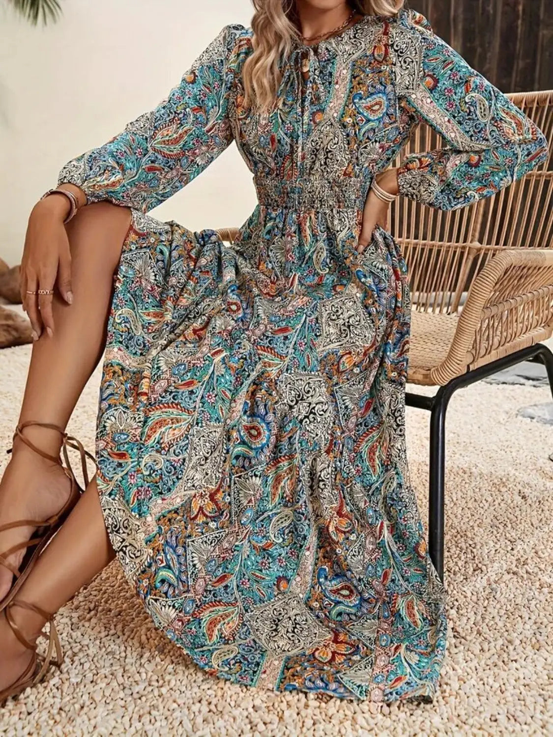 Printed tie neck long sleeve maxi dress with colorful paisley pattern and shirred waist