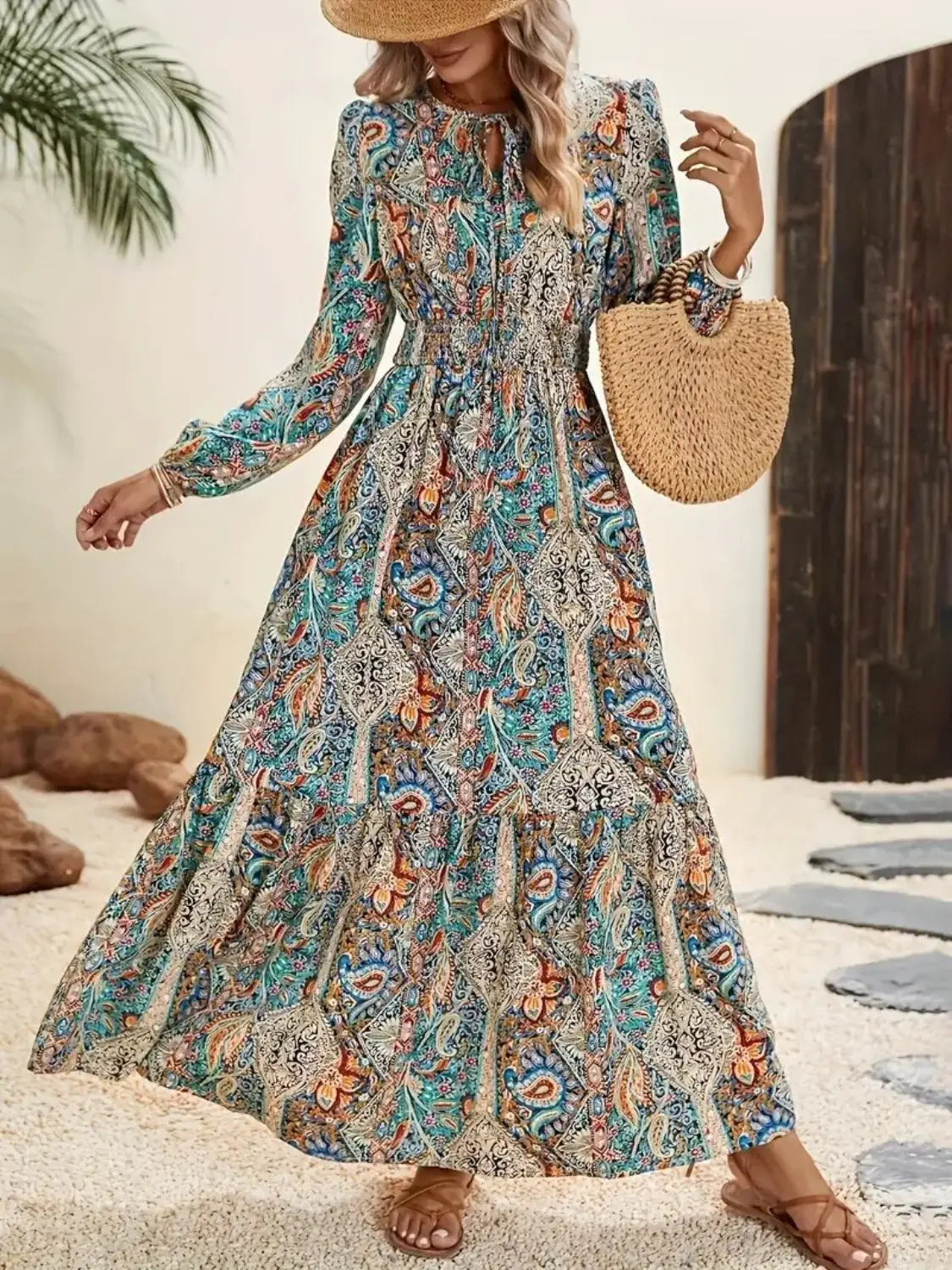 Long-sleeved printed tie neck maxi dress with colorful paisley pattern and shirred waist