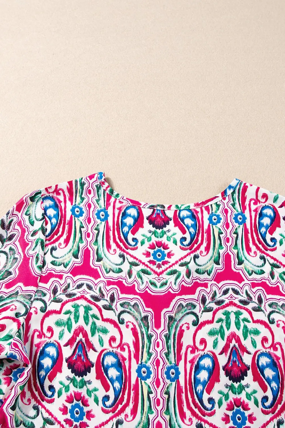 Vibrant paisley print top with a rounded neckline, perfect as a printed tie neck short sleeve dress
