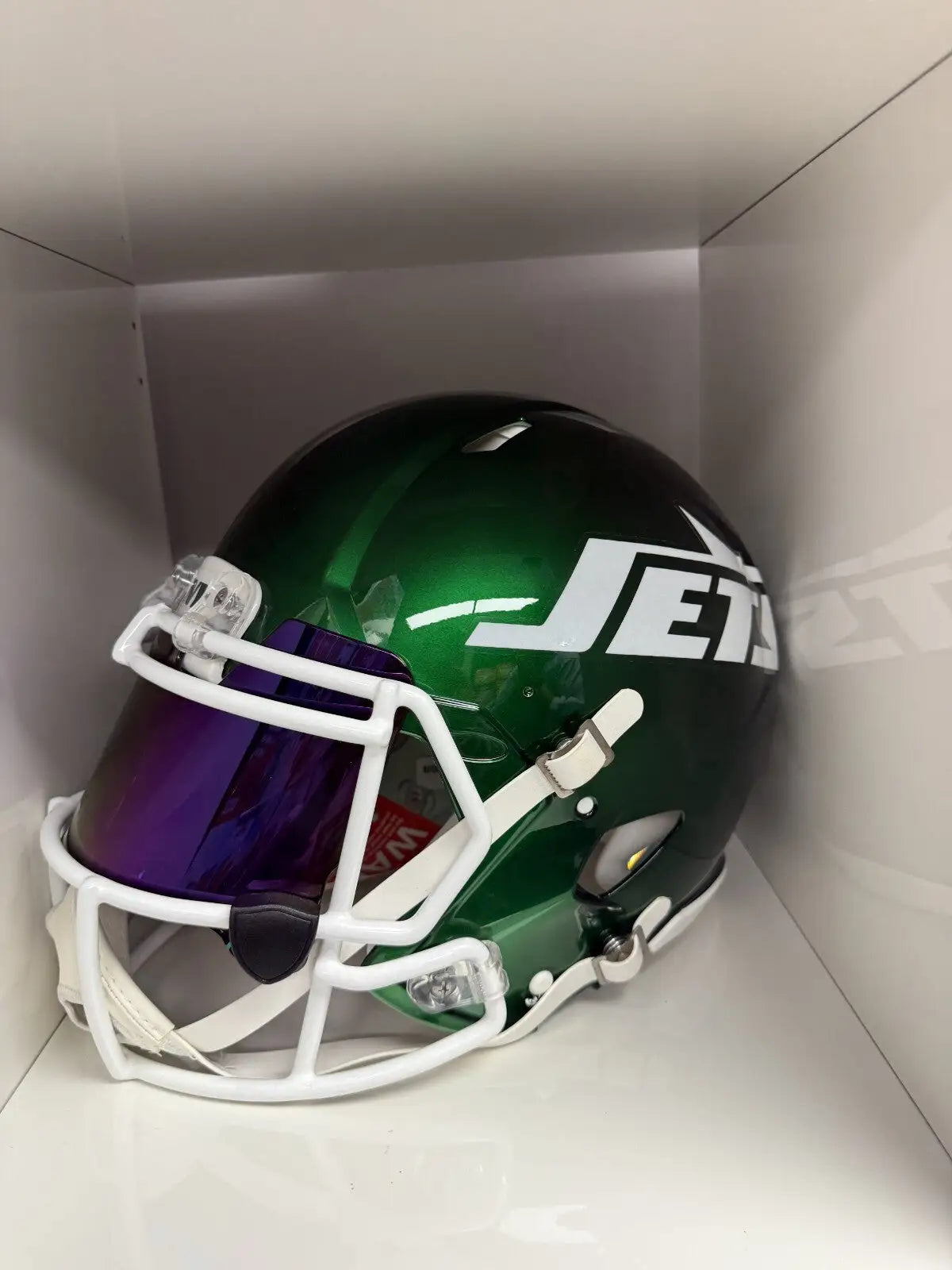 Green New York Jets football helmet with authentic autographed Quincy Williams signature