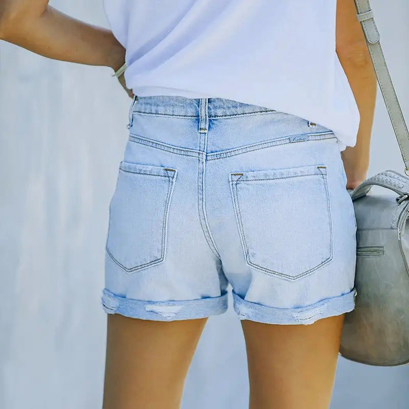 Light-wash ripped high waisted denim shorts with cuffed hems and distressed accents