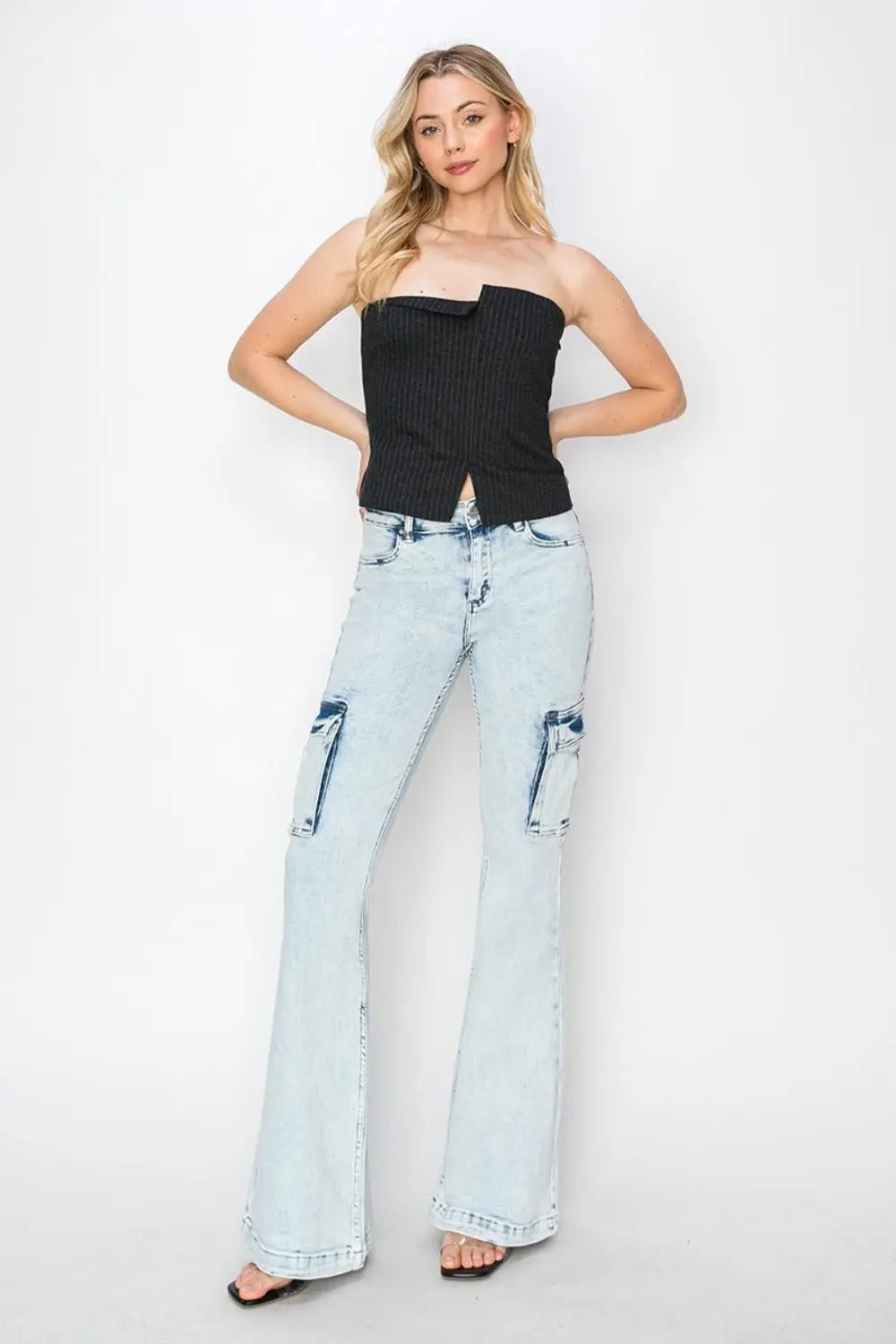 Women’s light wash RISEN cargo flare jeans featuring high rise and flare design