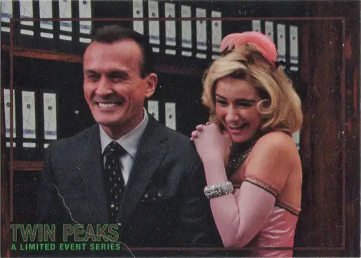 Smiling man in a suit and blonde woman in pink for Rittenhouse trading cards