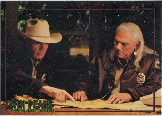 Two law enforcement officers reviewing documents at a table in a trading card scene
