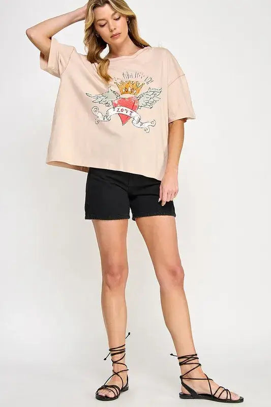 Peach love-inspired graphic oversized T-shirt with angel wings and heart design, black shorts