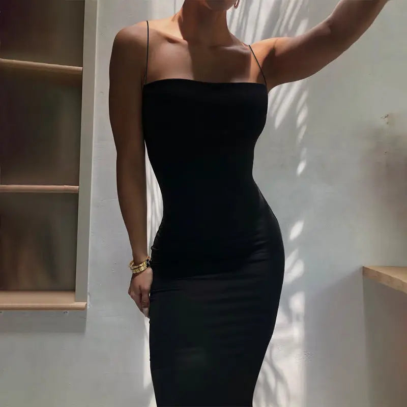 Sexy spaghetti strap bodycon maxi dress worn by woman in black midi dress perfect for business days