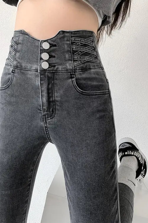 High-waisted vintage skinny pencil jeans with three front buttons and criss-cross side detailing