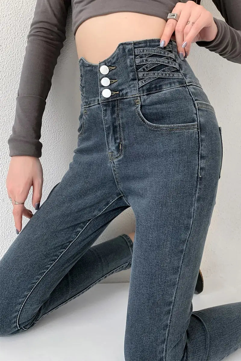 Vintage high waist skinny pencil jeans with three white buttons and criss-cross stitching