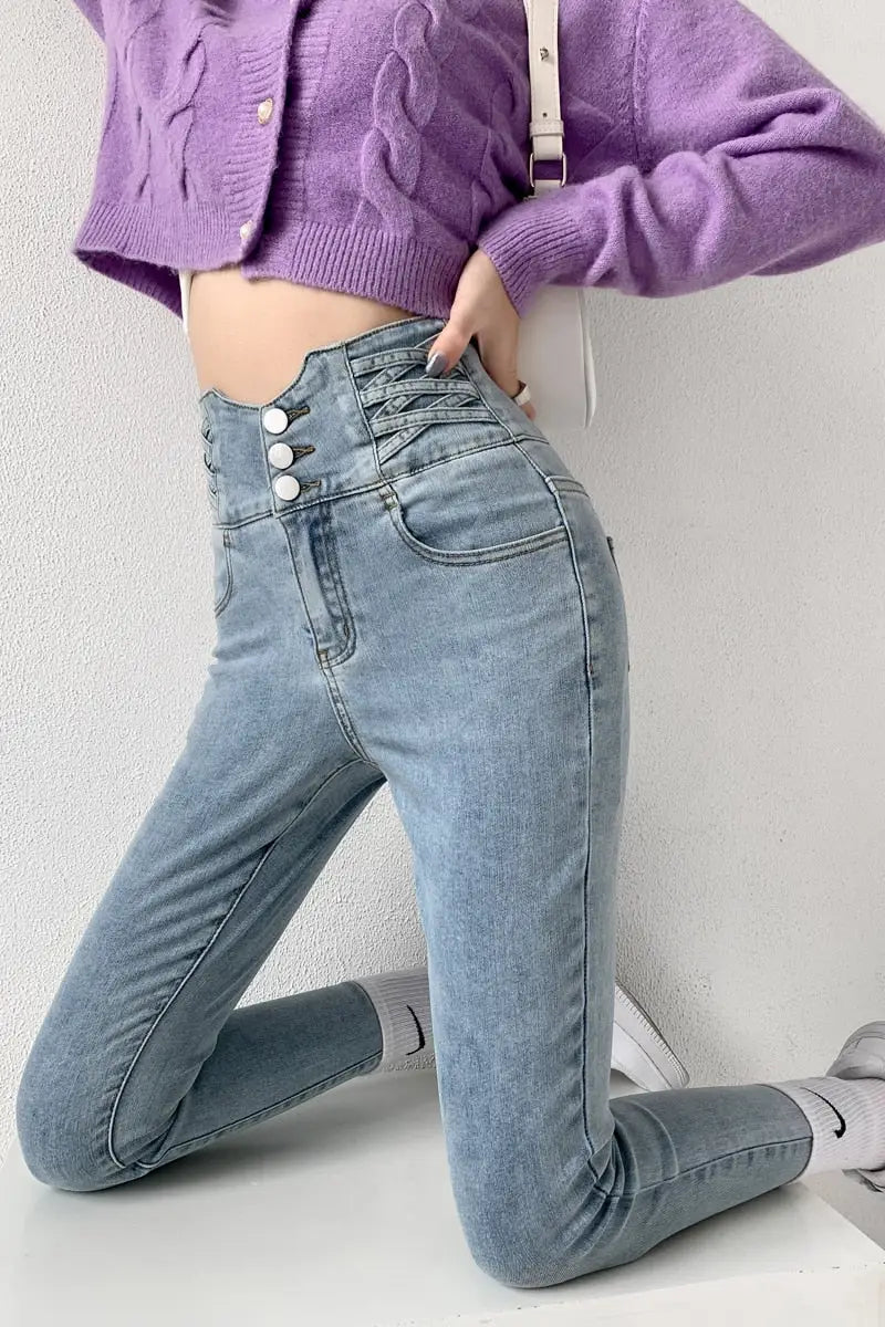 Light wash blue skinny pencil jeans with vintage high waist and three buttons