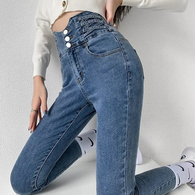 High-waisted vintage skinny pencil jeans with three buttons and criss-cross waist detail