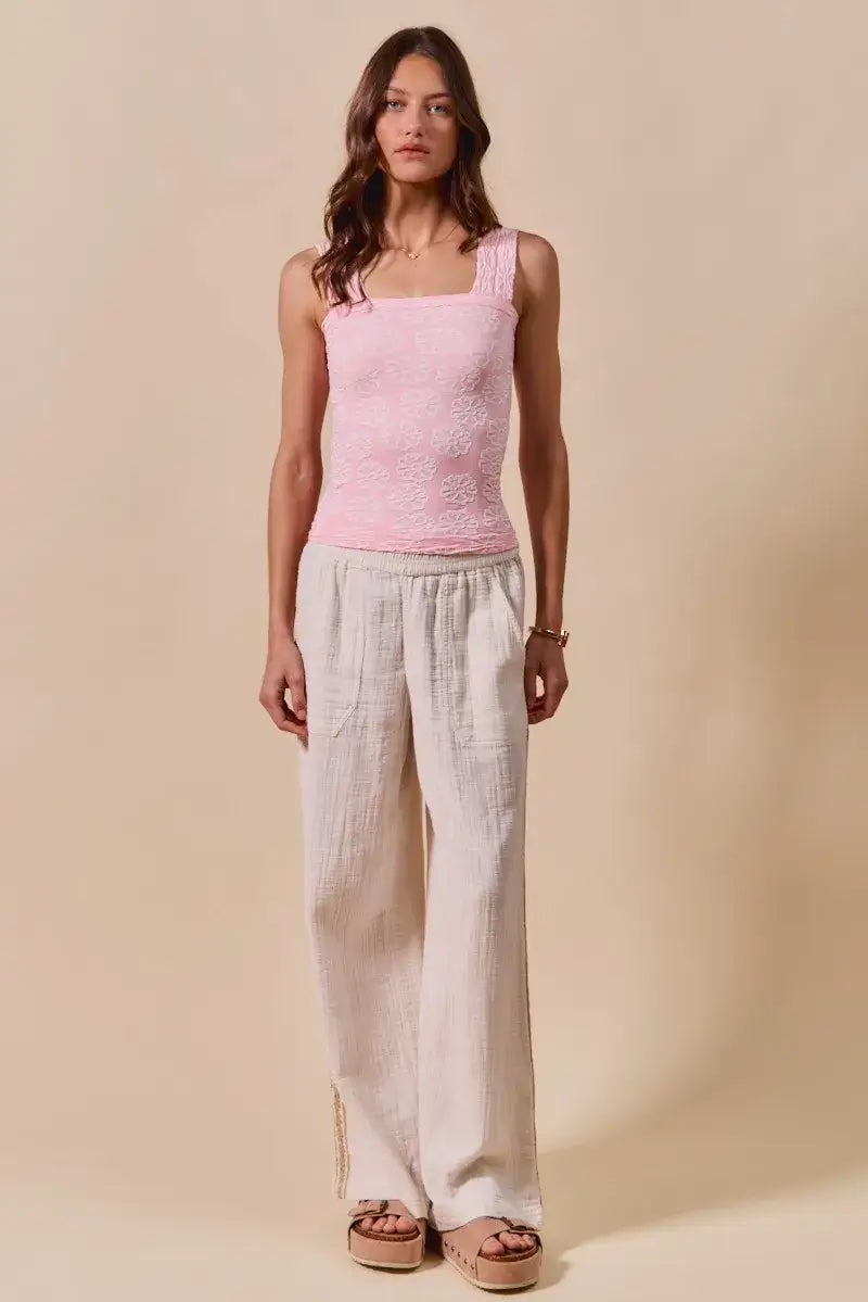 Woman modeling SO ME Two Tone Floral Seamless Tank Top with pink square-neck and beige wide-leg pants