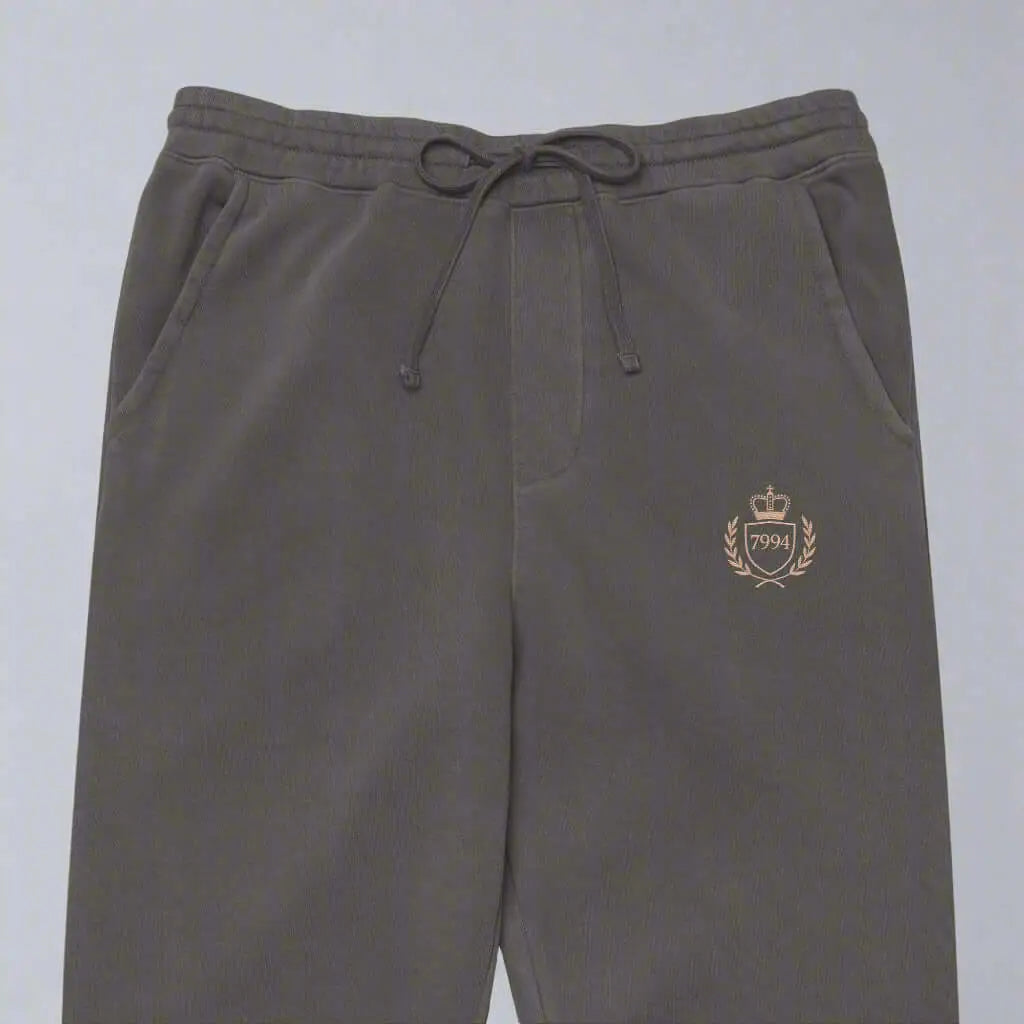 Gray crested luxe joggers with drawstring waist and embroidered crest for unisex style