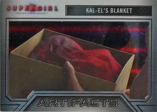Red blanket inside a cardboard box for Supergirl Season 1 Rainbow Foil Board Artifacts Chase