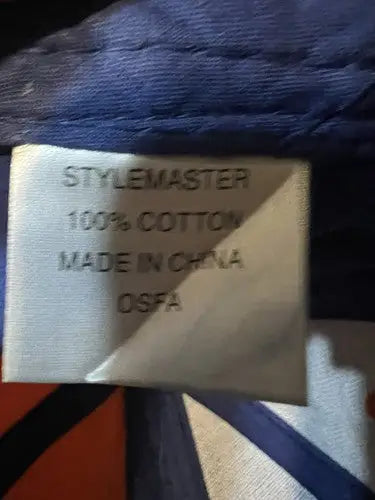 Fabric care label on Tide Racing Hat showing 100% Cotton and Made in China