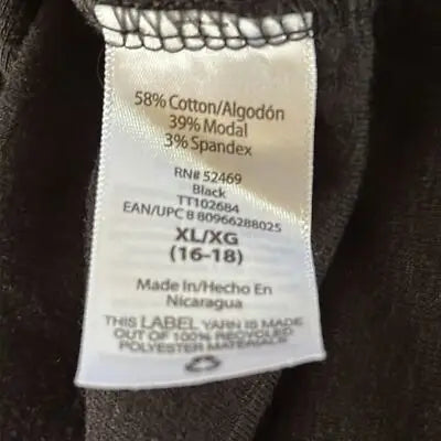 Clothing label showing material, size XL, color black, and manufacturing details for short sleeve blouse