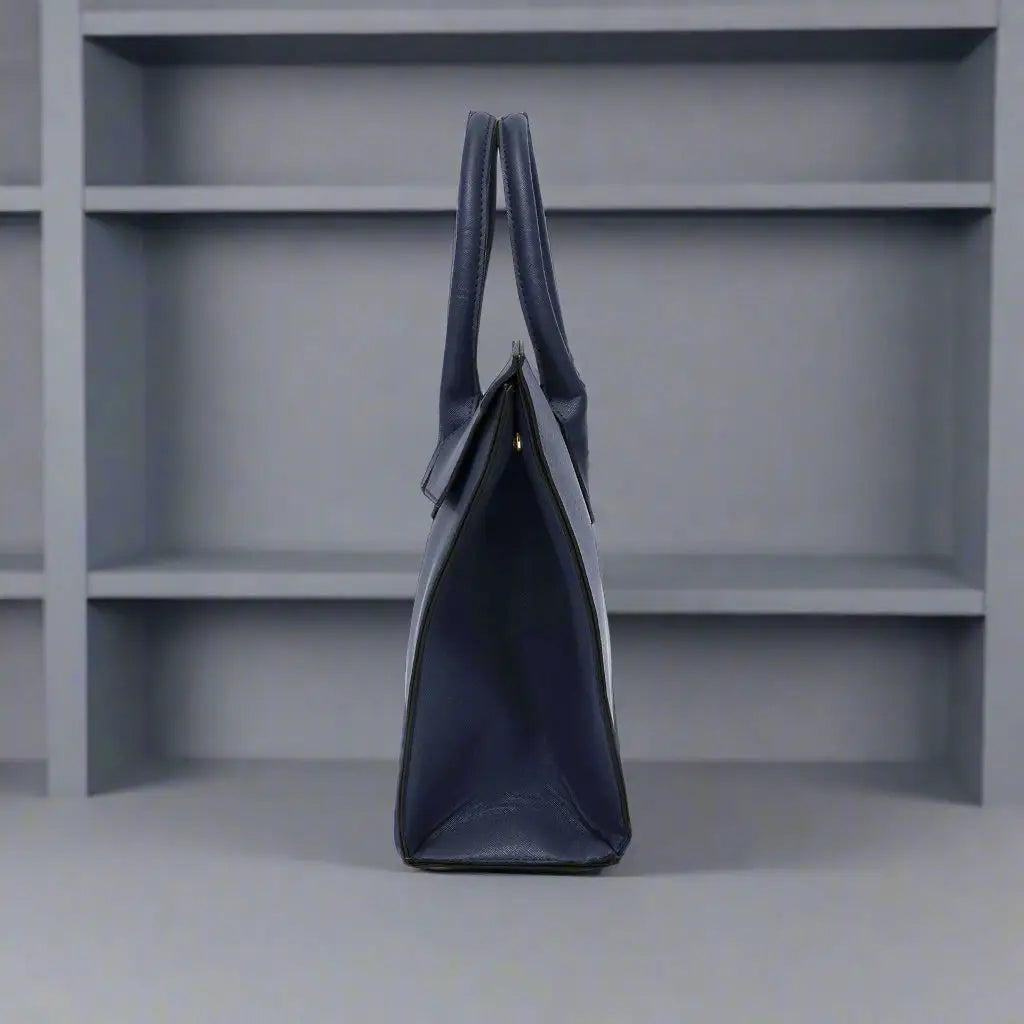 Navy synthetic leather handbag with two top handles and fold-over flap closure