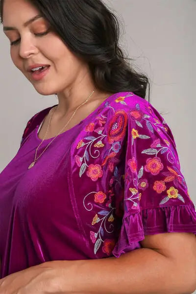 Woman wearing Umgee full size velvet embroidery short sleeve blouse with floral embroidered sleeves