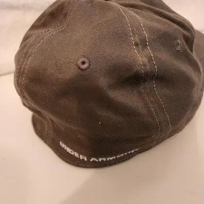 Dark brown Under Armour hat cap with white stitching and embroidered logo