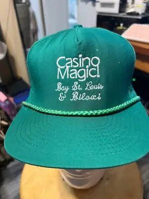 Green casino magic baseball cap with white embroidered text, adjustable unisex design