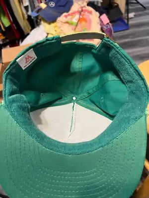 Green casino magic baseball cap with white lining and beige adjustable strap