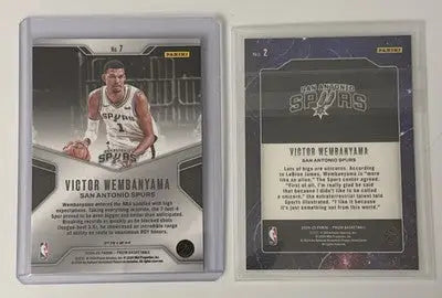 Two encased basketball trading cards from VICTOR WEMBANYAMA 2024-25 PANINI PRIZM DOMINANCE GREEN Deep Space Base