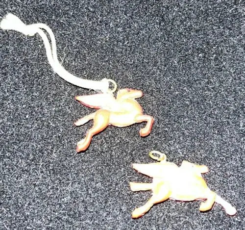 Two winged horse ornaments from Vintage Celluloid Mobil Oil Red Pegasus toy lot