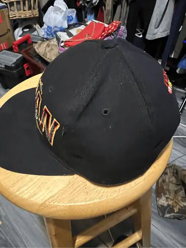 Black racing snapback hat with orange and yellow embroidered lettering in Vintage Nut Meg Ernie Irvin NASCAR style
