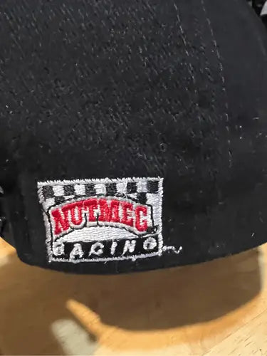 Black racing snapback hat with embroidered Nutmeg Racing logo from Vintage Nut Meg collection