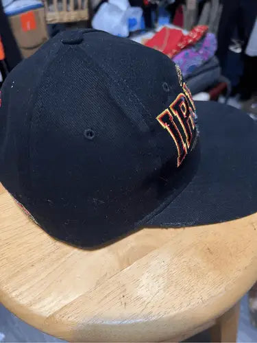 Black vintage Nut Meg Ernie Irvin NASCAR racing snapback hat with orange and brown lettering