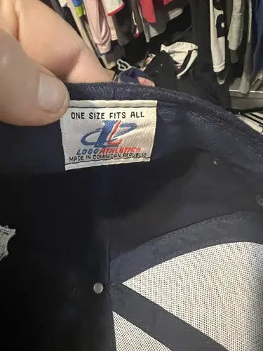 Dark-colored Dallas Cowboys hat cap with NFL logo and athletic striped design