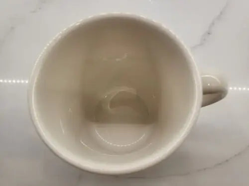 Empty off-white china coffee mug featuring England Patriots logo for collectors