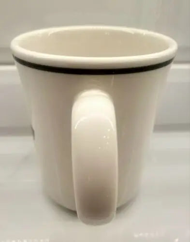 White ceramic china coffee mug with black rim featuring England Patriots logo