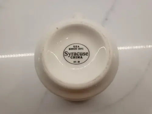 White ceramic creamer alongside Vtg NFL New England Patriots china coffee mug