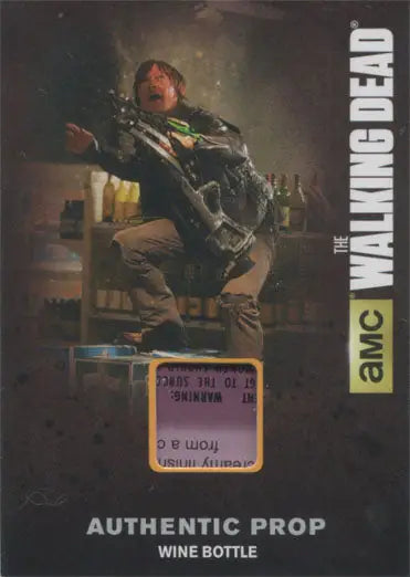 Man in action pose with a crossbow-like weapon from Walking Dead authentic prop trading card