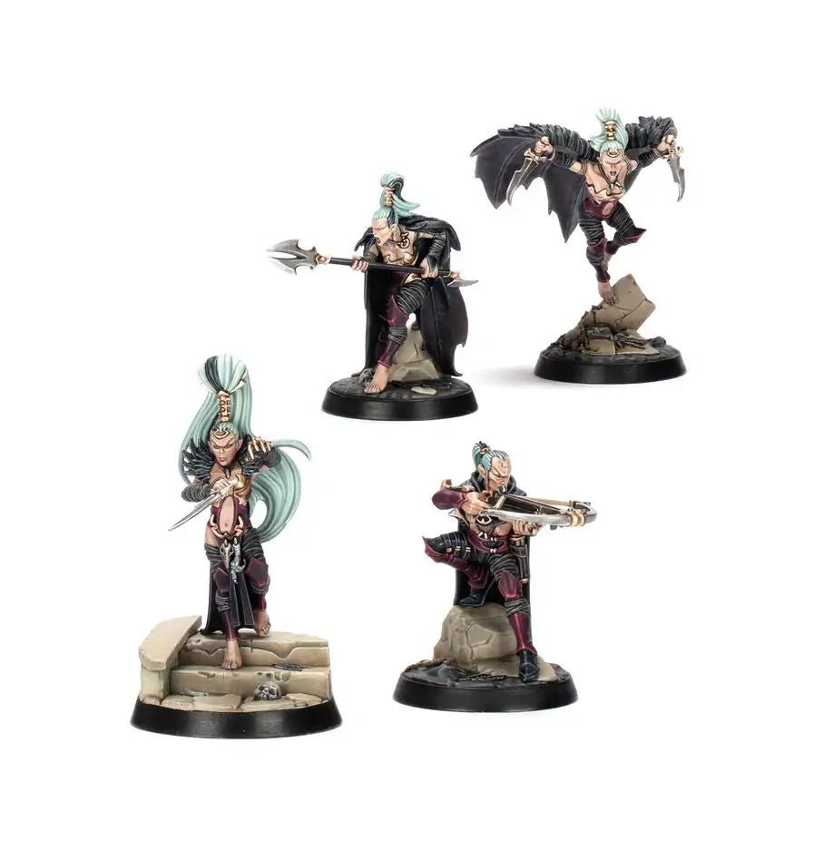 Four Warhammer miniatures from Warhammer Underworlds featuring warscroll cards and cards measure