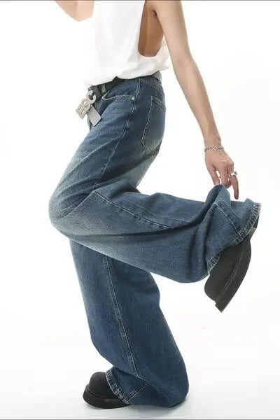 Wide leg blue denim jeans with pockets, white sleeveless top, and black shoes