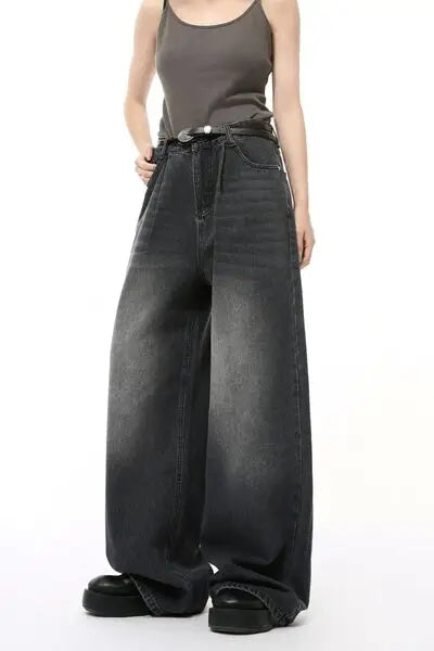 Washed black wide-leg jeans with pockets, dark grey tank top, and black platform shoes