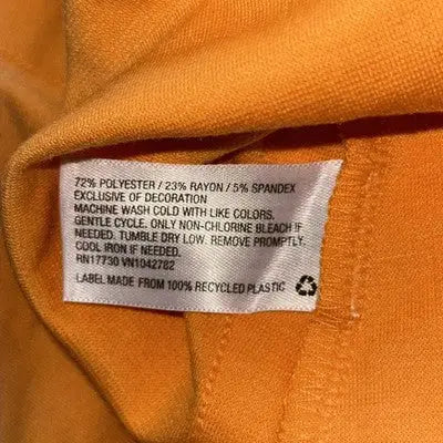 Orange fabric with white care label on Wild Fable retro tennis skirt high waist style