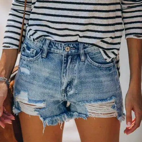 Women fringe denim jeans shorts featuring distressed denim and striped shirt, perfect for casual wear