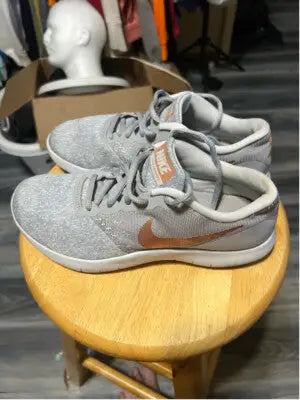 Light gray Nike Flex Contact running shoes with orange swoosh for women size 7.5