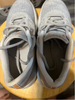 Light gray Nike Flex Contact running shoes with orange accents for women size 7.5