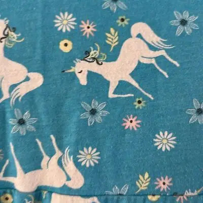 Light blue fabric with white unicorn and flower pattern for Wonder Nation Girls Blue Dress