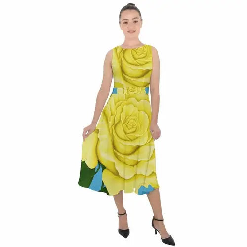 Woman in a yellow aqua rose chiffon dress with a blue and green patterned hem