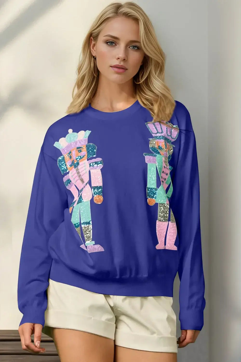 Royal blue sweatshirt with nutcracker design, cotton blend material.