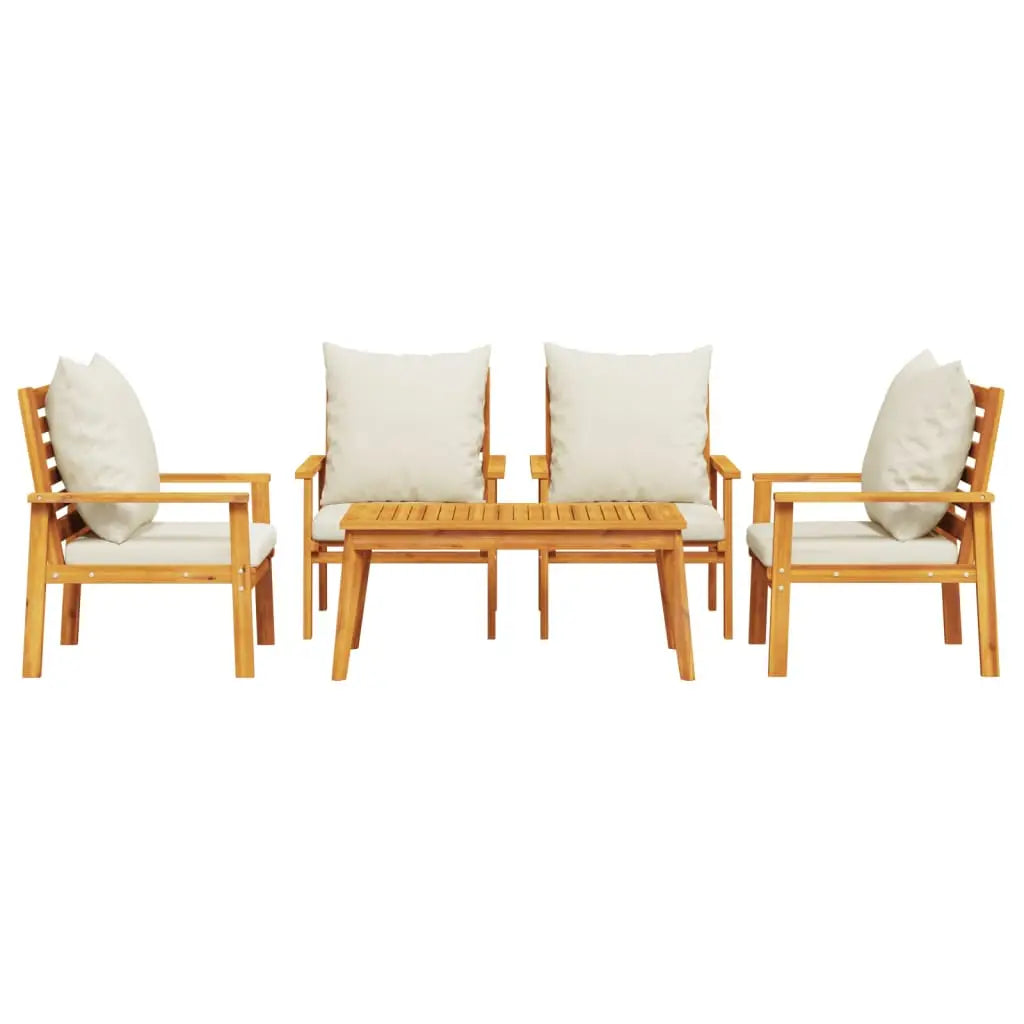 Teak wood outdoor furniture set with cream cushions and white polka dot pillows.
