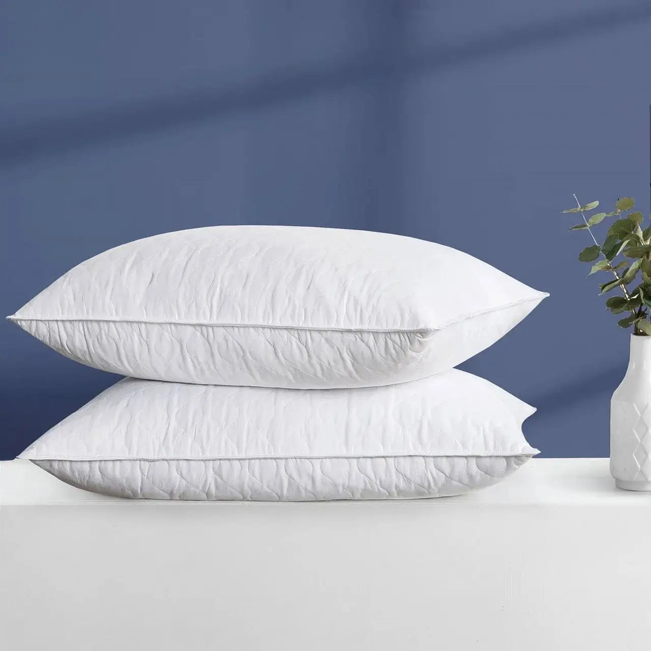 White down pillows with a quilted design and soft texture.