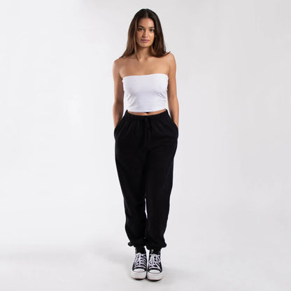 Black drawstring jogger pants with pockets and white Converse sneakers for women