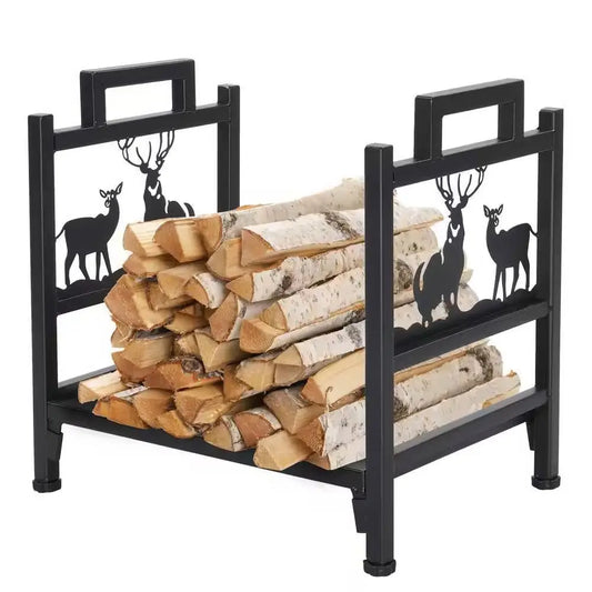 Black metal firewood log rack with deer pattern holding stacked birch logs